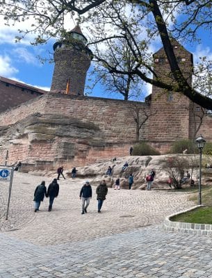 Children climb on stones in front of the Imperial Castle